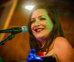 Carissa Look smiling at camera next to microphone